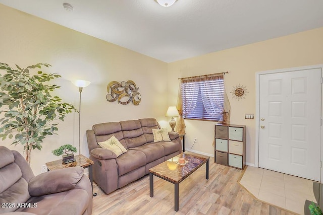 living area with light wood-style flooring and baseboards