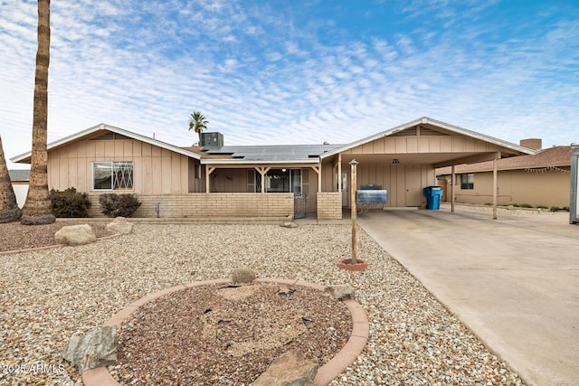 3410 W Pershing Ave, Phoenix, AZ 85029 - single story home with board and batten siding, concrete driveway, solar panels, brick siding, and central AC