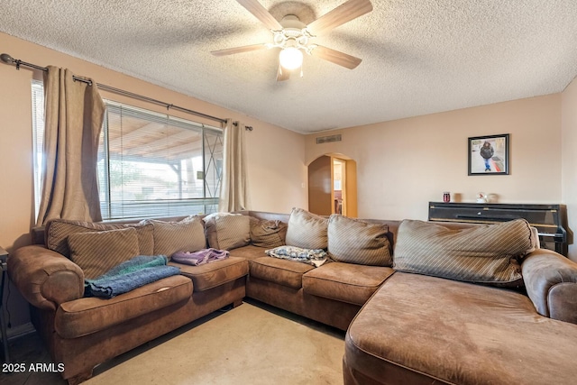 3410 W Pershing Ave, Phoenix, AZ 85029 - living room with arched walkways, ceiling fan, a textured ceiling, and light colored carpet