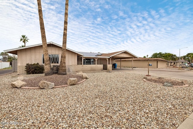 3410 W Pershing Ave, Phoenix, AZ 85029 - view of front of property featuring brick siding, board and batten siding, and solar panels