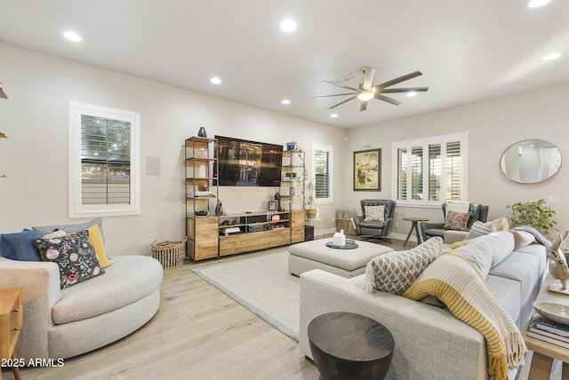 living room featuring ceiling fan and light wood-type flooring