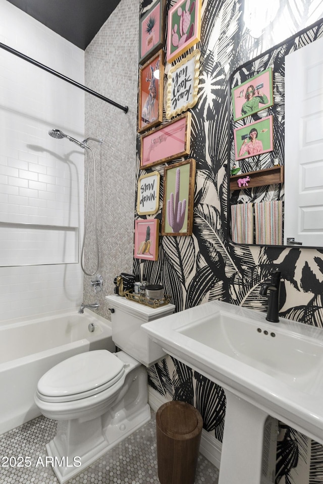 full bathroom with tile patterned flooring, sink, toilet, and tiled shower / bath