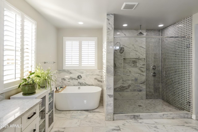 bathroom with independent shower and bath, vanity, and tile walls