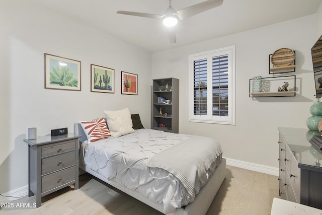 bedroom with light hardwood / wood-style flooring and ceiling fan