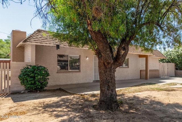649 S Temple St, Mesa, AZ 85204 - view of front of property with a chimney, stucco siding, and a patio area