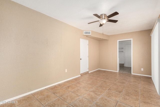 649 S Temple St, Mesa, AZ 85204 - unfurnished bedroom with light tile patterned floors, a ceiling fan, baseboards, and a spacious closet
