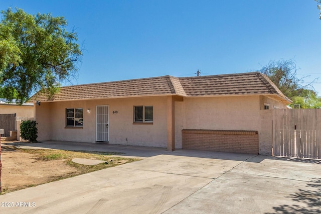 649 S Temple St, Mesa, AZ 85204 - view of front of house with mansard roof, stucco siding, concrete driveway, and an attached garage