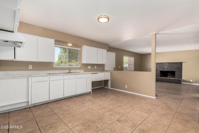 649 S Temple St, Mesa, AZ 85204 - kitchen with a sink, light countertops, under cabinet range hood, light tile patterned floors, and white cabinets