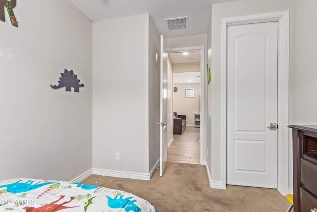 bedroom featuring light colored carpet