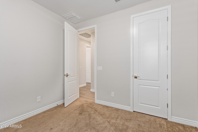 unfurnished bedroom featuring light colored carpet