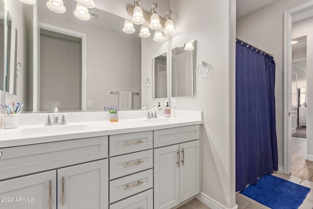 bathroom with tile patterned floors and vanity