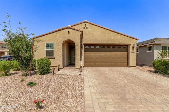 mediterranean / spanish-style house featuring a garage