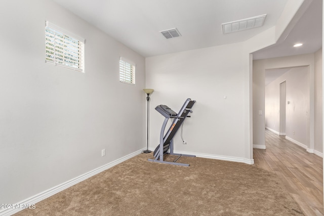 exercise area featuring hardwood / wood-style flooring