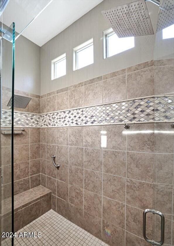 bathroom featuring a shower with shower door