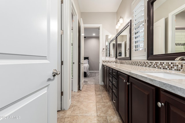 bathroom with vanity, backsplash, and tile patterned flooring