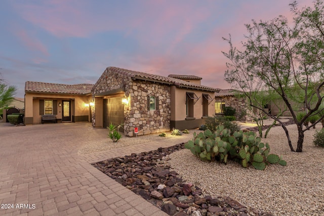 mediterranean / spanish-style home with a garage