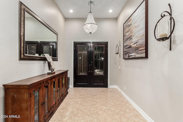 entrance foyer with french doors and a chandelier