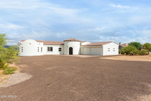 mediterranean / spanish house with a garage