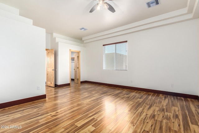 empty room with hardwood / wood-style flooring and ceiling fan