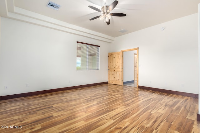 empty room with ceiling fan and wood-type flooring