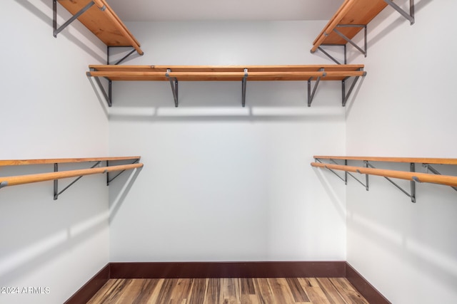 walk in closet with hardwood / wood-style floors