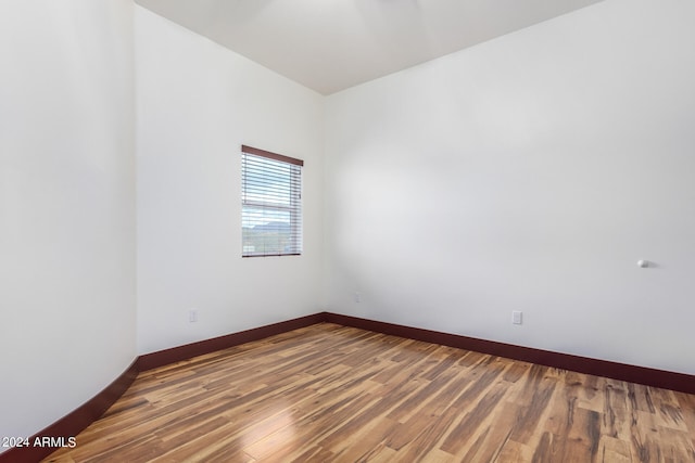 unfurnished room with hardwood / wood-style flooring