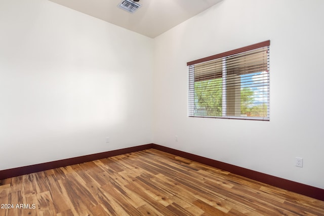 spare room featuring wood-type flooring