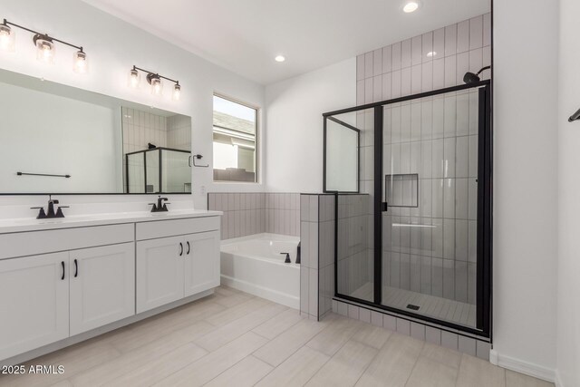 bathroom with tile patterned floors, separate shower and tub, and vanity