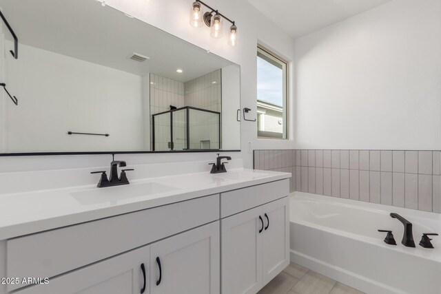 bathroom with vanity, plus walk in shower, and tile patterned flooring