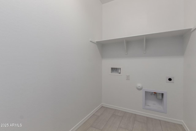 clothes washing area featuring gas dryer hookup, washer hookup, light hardwood / wood-style flooring, and electric dryer hookup