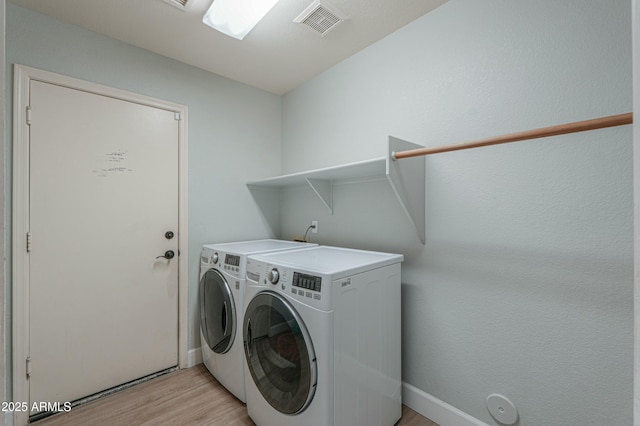 2218 E Anchor Dr, Gilbert, AZ 85234 - clothes washing area with light wood-style floors, washing machine and clothes dryer, baseboards, and laundry area