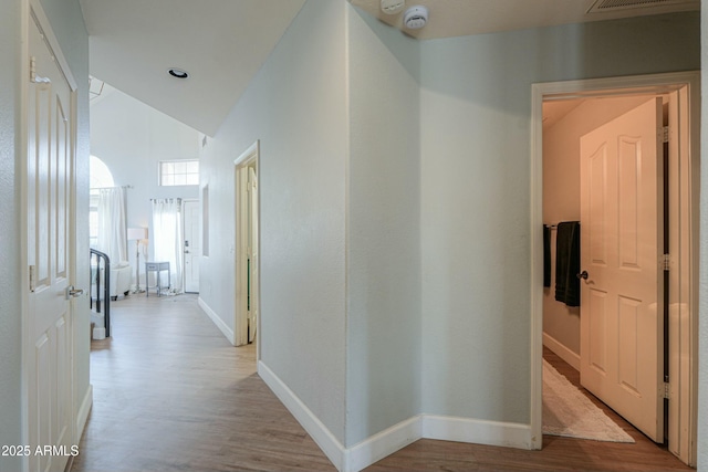 2218 E Anchor Dr, Gilbert, AZ 85234 - corridor featuring baseboards, lofted ceiling, and light wood-style flooring