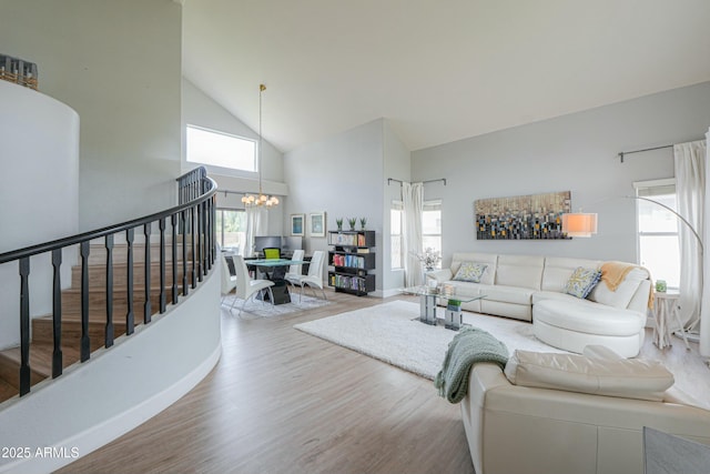 2218 E Anchor Dr, Gilbert, AZ 85234 - living room featuring high vaulted ceiling, stairs, wood finished floors, a chandelier, and a healthy amount of sunlight