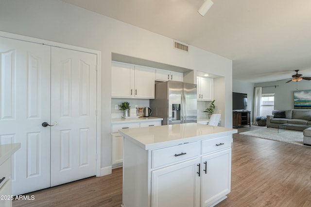 2218 E Anchor Dr, Gilbert, AZ 85234 - kitchen featuring stainless steel fridge, open floor plan, visible vents, a ceiling fan, and wood finished floors