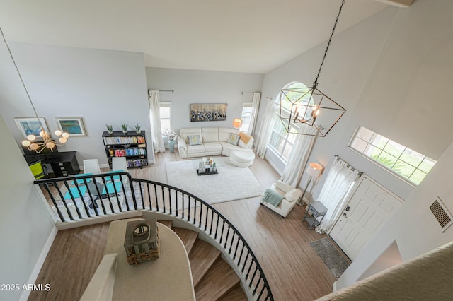 2218 E Anchor Dr, Gilbert, AZ 85234 - stairway with a high ceiling, wood finished floors, visible vents, baseboards, and a chandelier