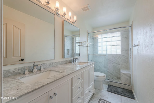 2218 E Anchor Dr, Gilbert, AZ 85234 - bathroom with double vanity, toilet, a stall shower, and a sink