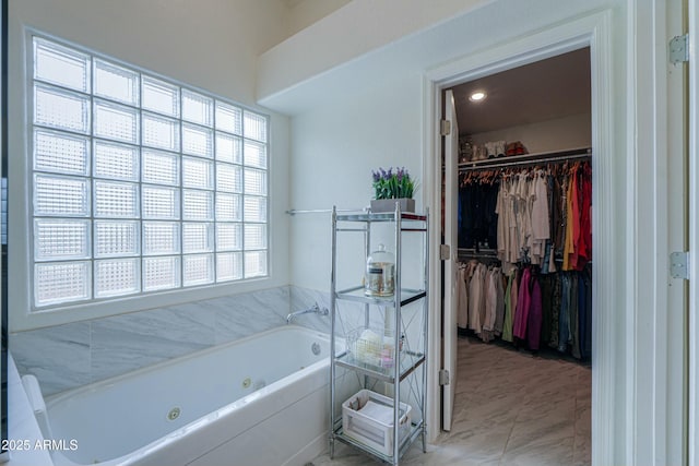 2218 E Anchor Dr, Gilbert, AZ 85234 - bathroom featuring a walk in closet, marble finish floor, and a tub with jets
