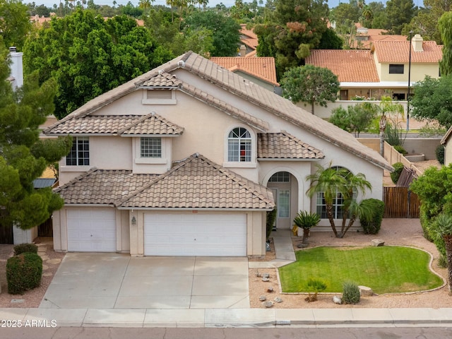2218 E Anchor Dr, Gilbert, AZ 85234 - mediterranean / spanish home with a tile roof, concrete driveway, fence, an attached garage, and stucco siding