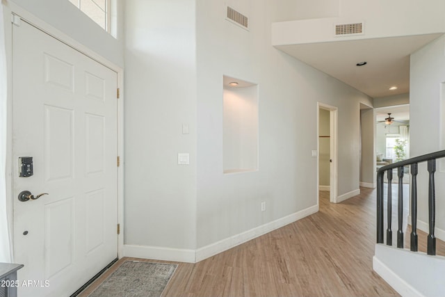 2218 E Anchor Dr, Gilbert, AZ 85234 - foyer entrance with baseboards, a ceiling fan, light wood finished floors, and visible vents