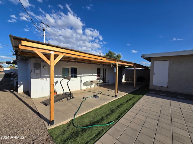 back of property featuring french doors and a patio