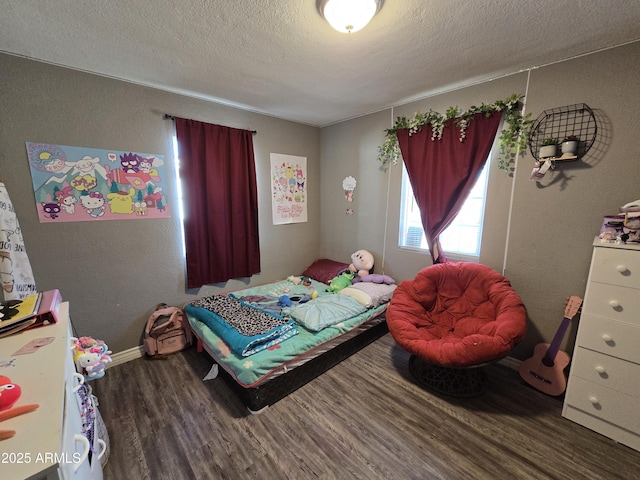 bedroom with hardwood / wood-style flooring and a textured ceiling