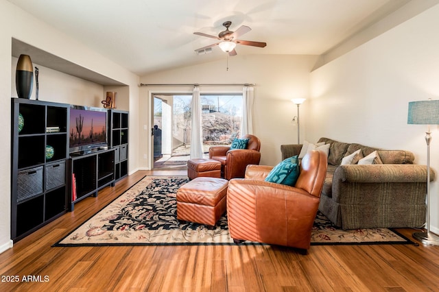 living room with hardwood / wood-style floors, ceiling fan, and vaulted ceiling