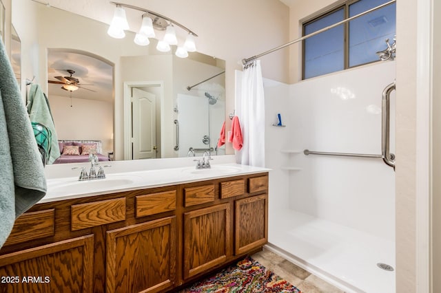 bathroom featuring ceiling fan, a shower with shower curtain, and vanity