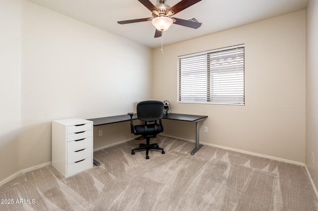 unfurnished office featuring light colored carpet and ceiling fan