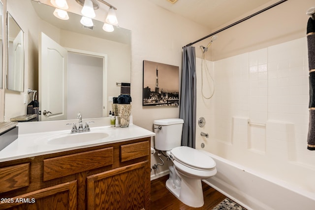 full bathroom featuring toilet, hardwood / wood-style flooring, shower / bathtub combination with curtain, and vanity