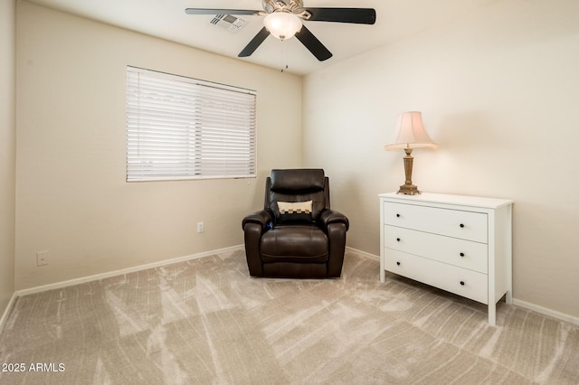 sitting room featuring light colored carpet and ceiling fan