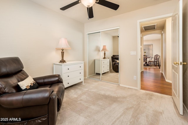 sitting room with light carpet and ceiling fan