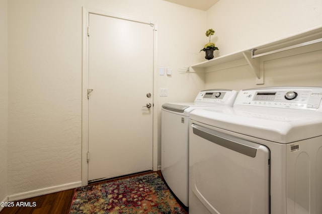 laundry area with dark hardwood / wood-style floors and independent washer and dryer