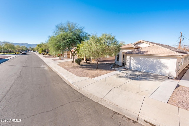 view of front of property featuring a garage and a mountain view