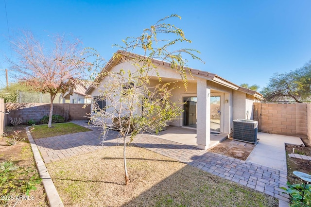 back of property featuring a patio and central air condition unit